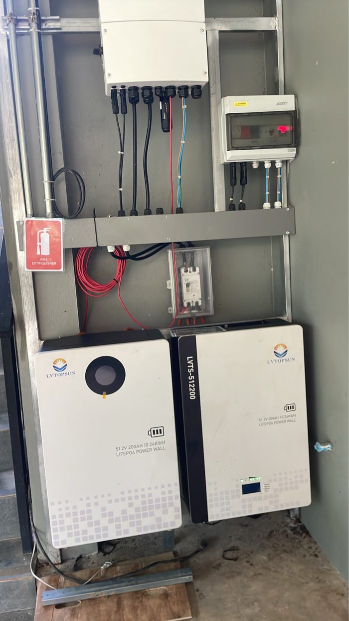 Two 10.24 kWh LiFePO4 wall batteries side by side below a Solis hybrid inverter