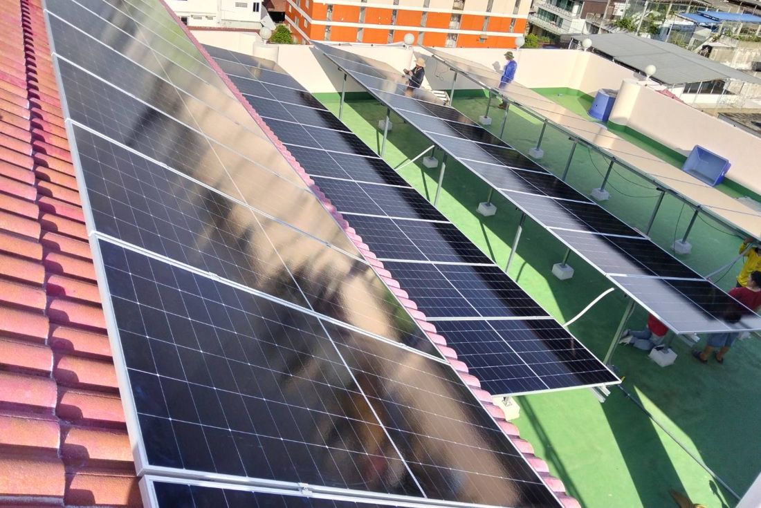 Panels on the tiled roof and on frames over the flat roof deck
