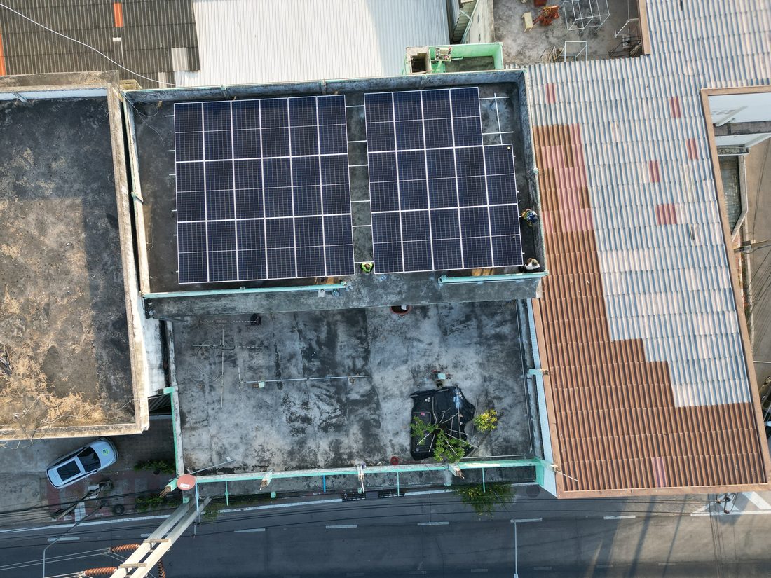 The array from above: two groups on frames over a flat concrete roof