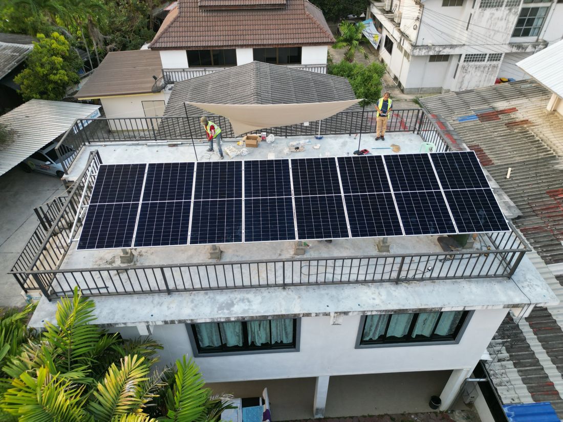The array on a flat concrete roof deck with railing